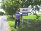 Simon next to village sign.